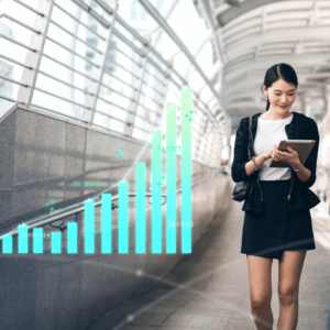 A focused young woman walking in a quiet hallway of an office building engrossed in her tablet. A visible image of chart next to her signifies the constant monitoring and assessment of financial strategies. This image symbolizes the integration of financial planning and everyday life for young adults in Singapore.