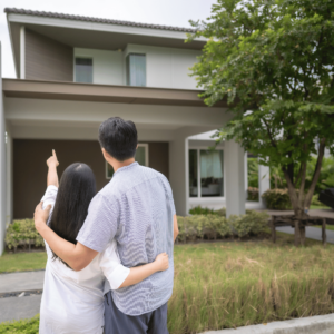 A happy couple stands in front of a modern suburban house in Singapore, exploring financing options for home ownership after their wedding, symbolizing major life events and financial planning including their wedding in Singapore.