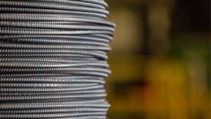 Steel coils representing industrial demand within US equities as Nucor stock approaches record highs driven by strong infrastructure growth