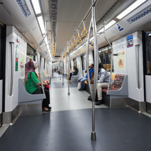 Commuters seated in a public train in Singapore, partaking in efficient, cost-effective transportation as part of personal budgeting strategies.