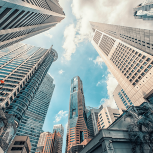 Bright, broad daylight showcasing Singapore's towering business district. Clear skies highlight the city's infrastructure grandeur, which serves as a backdrop for the evolution of personal finance best practices in Singapore.