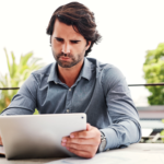 a man is rebalancing portfolio using his tablet
