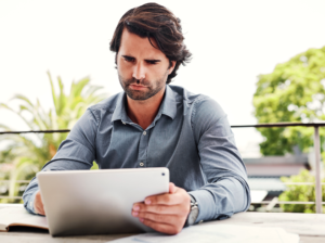 a man is rebalancing portfolio using his tablet